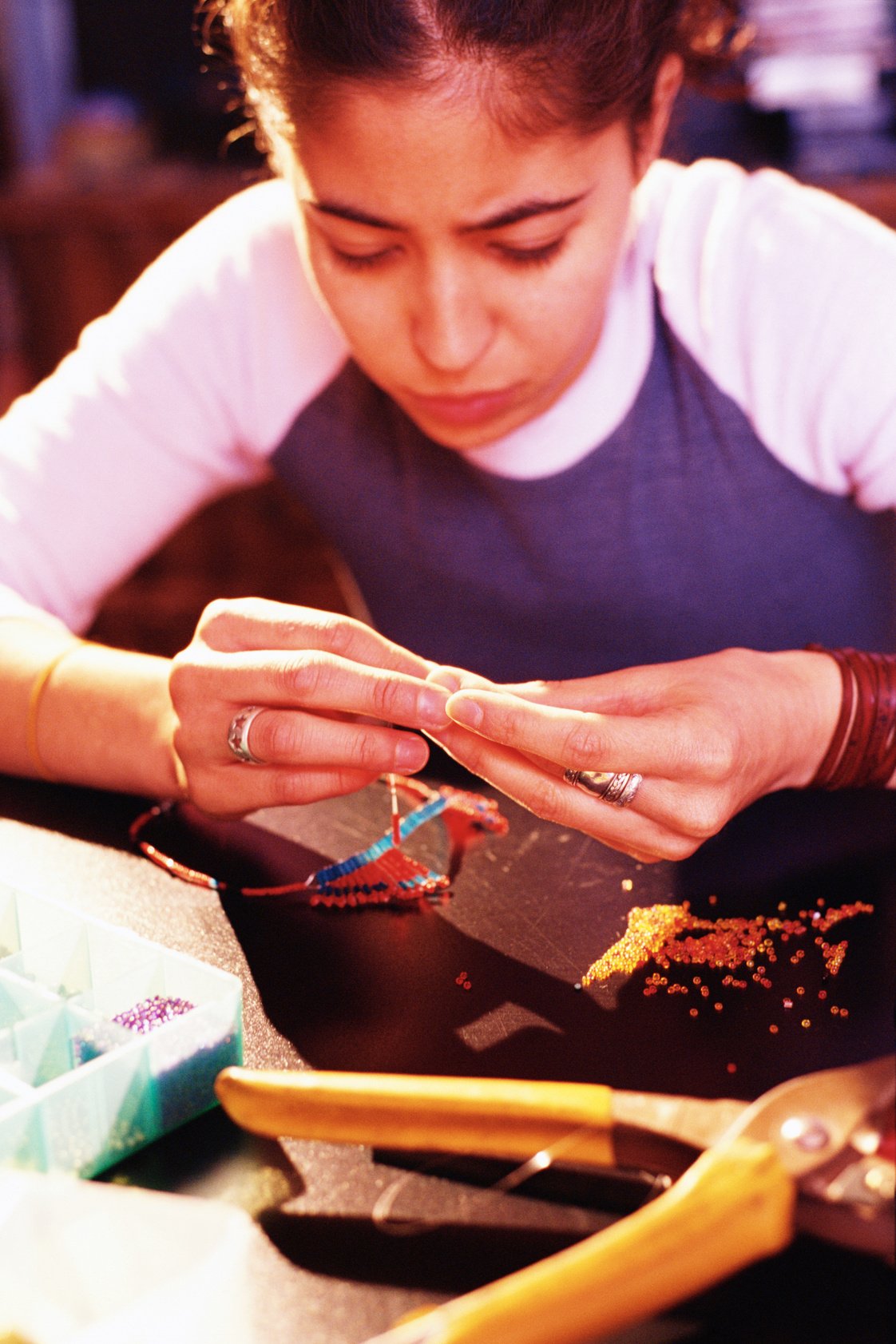 Teenage girl doing beadwork